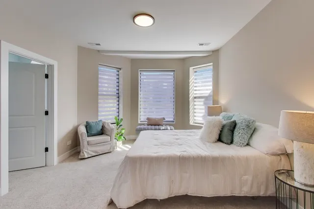 a bedroom with a bed and window