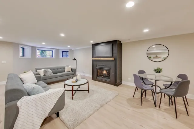 a living room with furniture a fireplace and kitchen view