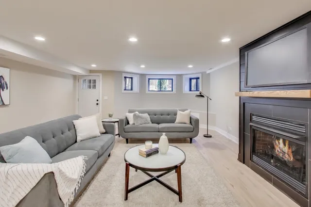a living room with furniture and a fireplace