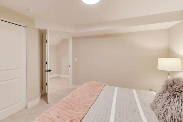 a bedroom with a bed and a rug