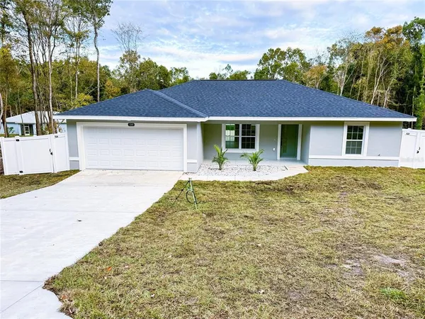a front view of a house with yard patio and green space