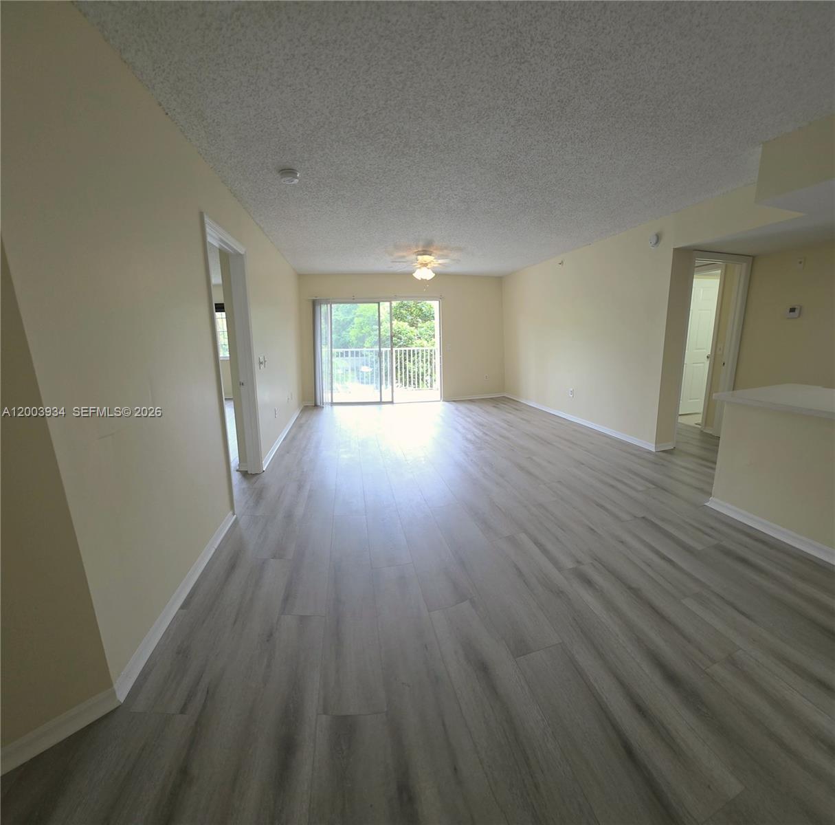 5051 Wiles Road, Unit 201 Coconut Creek, FL 33073 - Photo 14 of 43 wooden floor in an empty room with a window