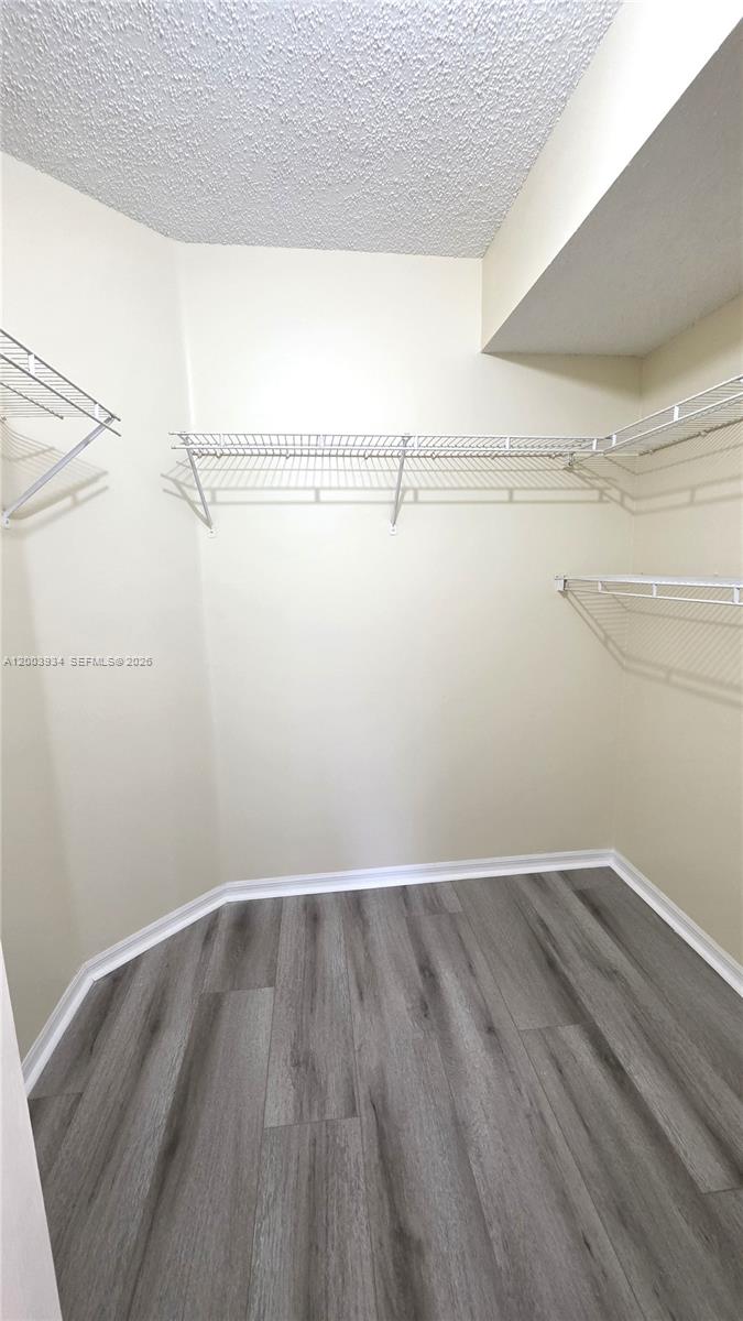 5051 Wiles Road, Unit 201 Coconut Creek, FL 33073 - Photo 19 of 43 a view of a room with racks on the wall