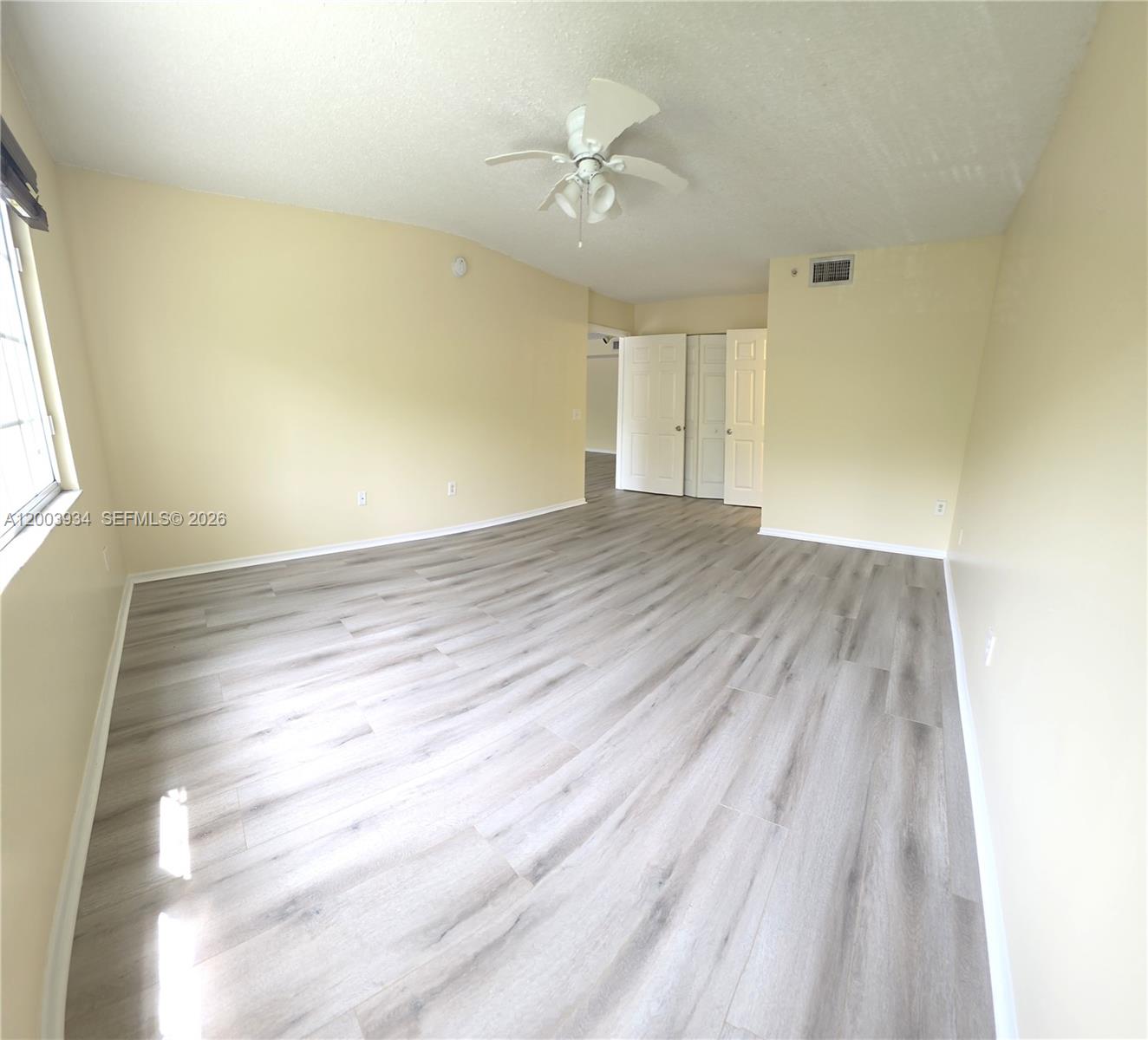 5051 Wiles Road, Unit 201 Coconut Creek, FL 33073 - Photo 21 of 43 wooden floor in an empty room with a window
