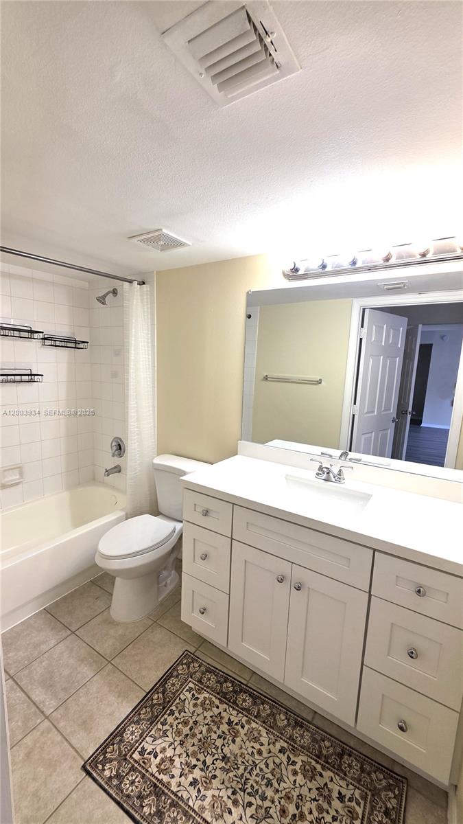 5051 Wiles Road, Unit 201 Coconut Creek, FL 33073 - Photo 22 of 43 a bathroom with a granite countertop toilet a sink and a bathtub