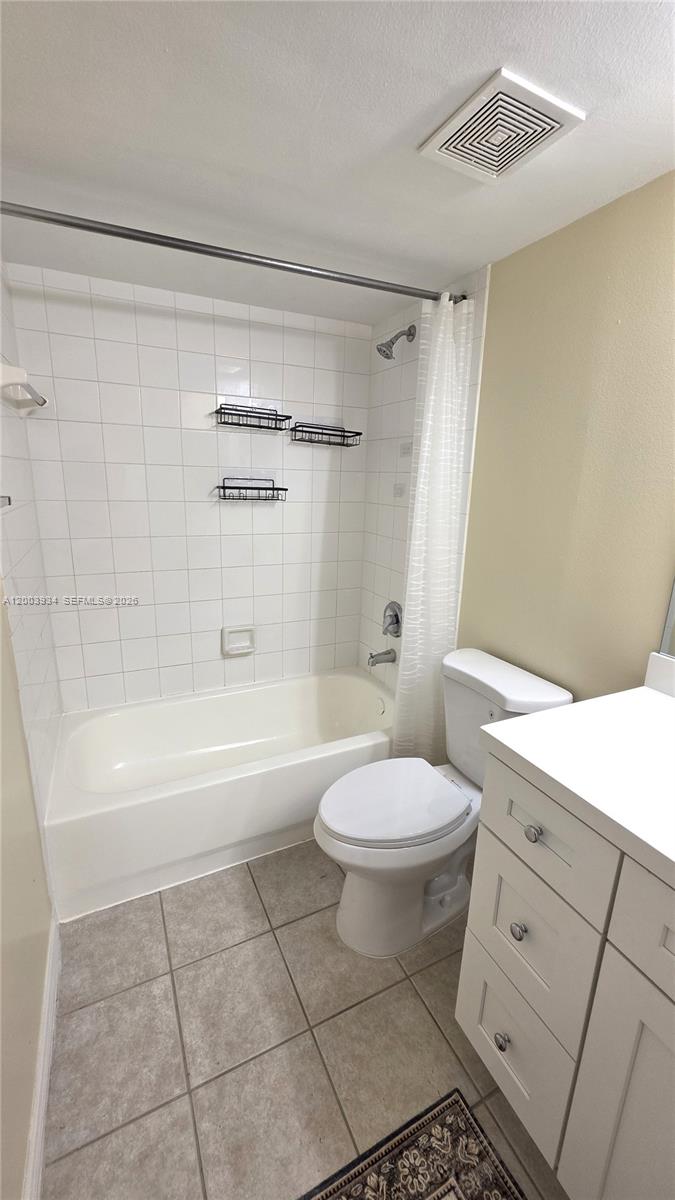 5051 Wiles Road, Unit 201 Coconut Creek, FL 33073 - Photo 23 of 43 a bathroom with a toilet a sink and bathtub