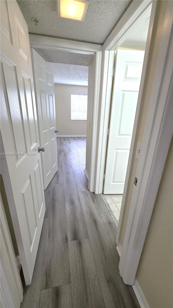5051 Wiles Road, Unit 201 Coconut Creek, FL 33073 - Photo 29 of 43 a view of a room with wooden floor and staircase