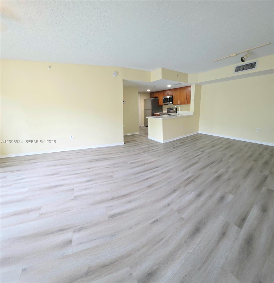 5051 Wiles Road, Unit 201 Coconut Creek, FL 33073 - Photo 3 of 43 a view of a room with wooden floor