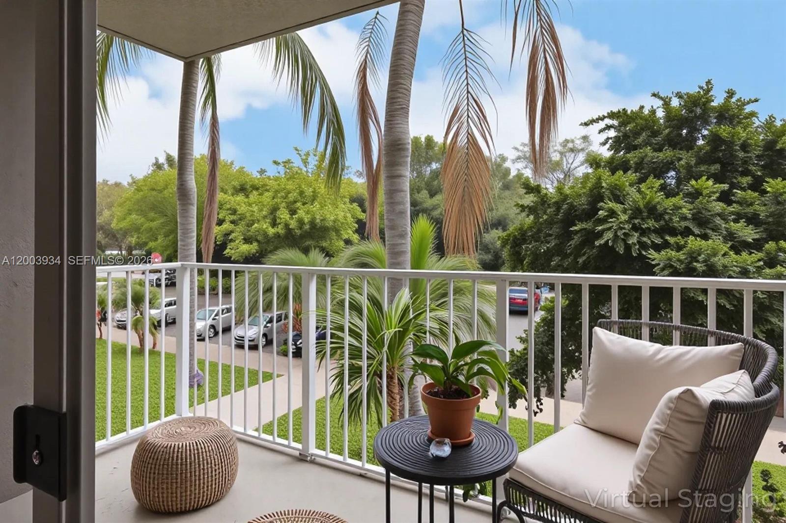 5051 Wiles Road, Unit 201 Coconut Creek, FL 33073 - Photo 32 of 43 a balcony with chairs and potted plants