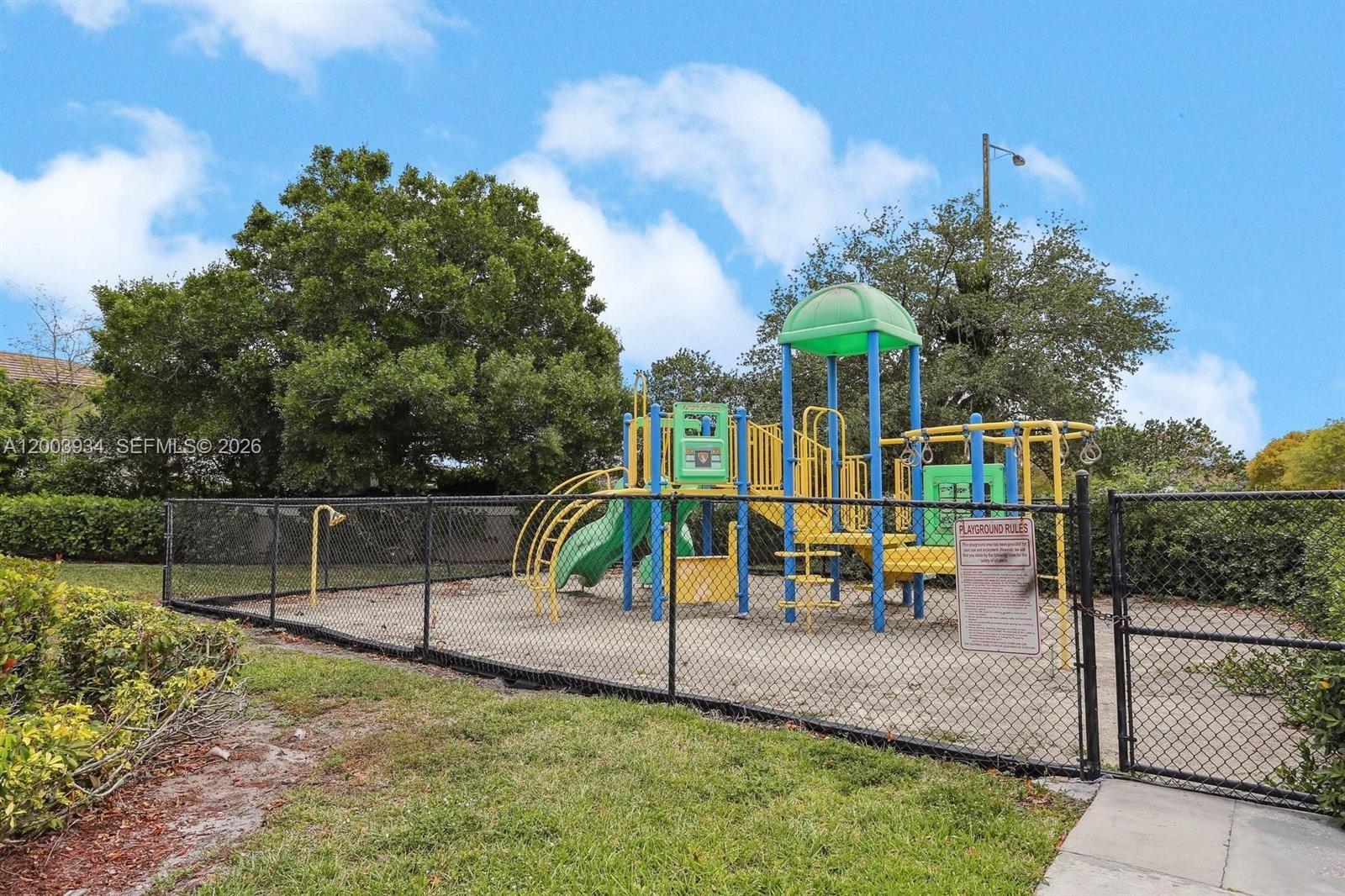 5051 Wiles Road, Unit 201 Coconut Creek, FL 33073 - Photo 39 of 43 a view of a park with swings