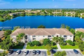 5051 Wiles Road, Unit 201 Coconut Creek, FL 33073 - Photo 41 of 43 an aerial view of a house with a lake view