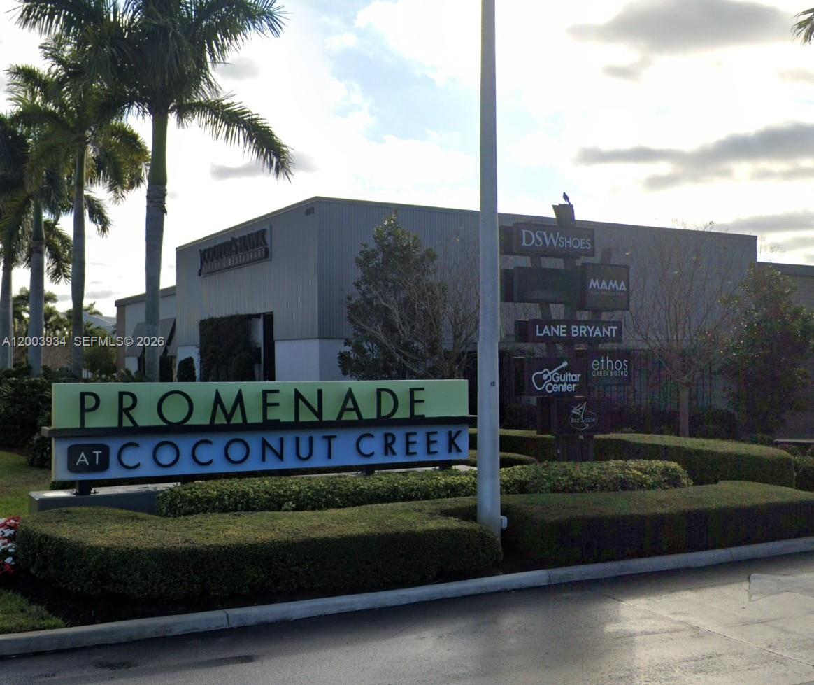 5051 Wiles Road, Unit 201 Coconut Creek, FL 33073 - Photo 43 of 43 a street sign on the side of building