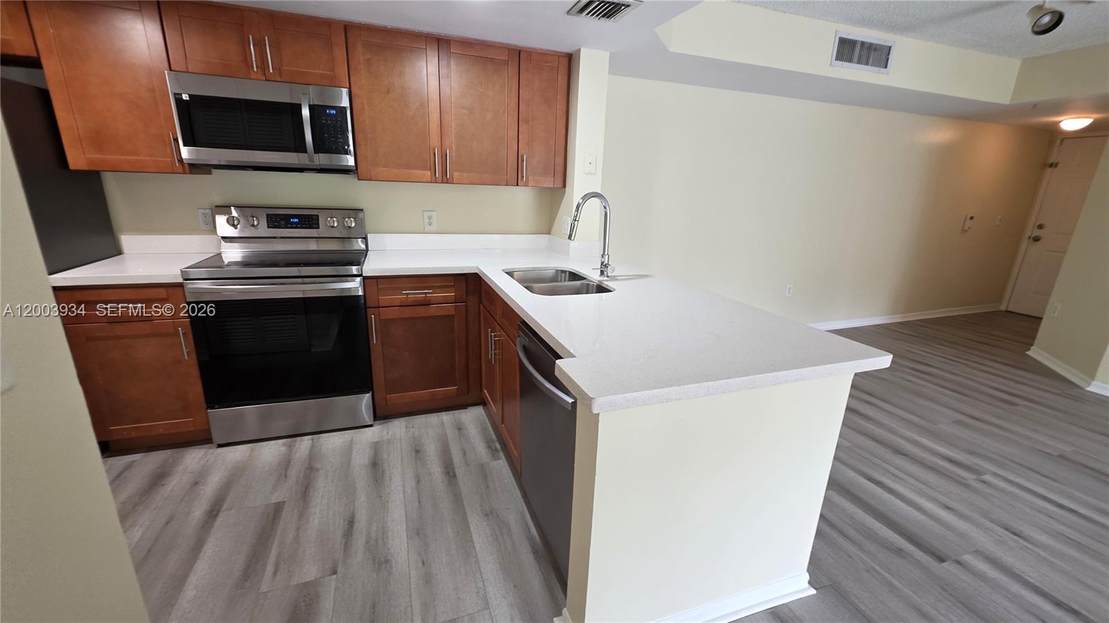 5051 Wiles Road, Unit 201 Coconut Creek, FL 33073 - Photo 6 of 43 a kitchen with a sink and a stove top oven