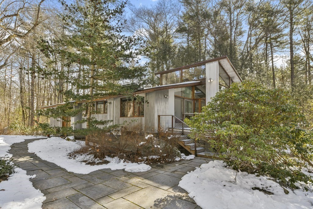 a view of a backyard with table and chairs and potted plants