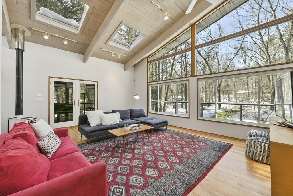 87 Wolf Rock Road Carlisle, MA 01741 - Photo 12 of 28 a living room with furniture and large windows