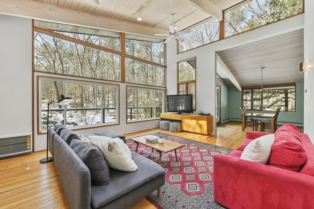 87 Wolf Rock Road Carlisle, MA 01741 - Photo 13 of 28 a living room with furniture and a floor to ceiling window