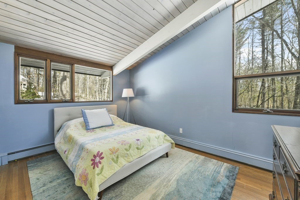 87 Wolf Rock Road Carlisle, MA 01741 - Photo 19 of 28 a bedroom with a bed and a window