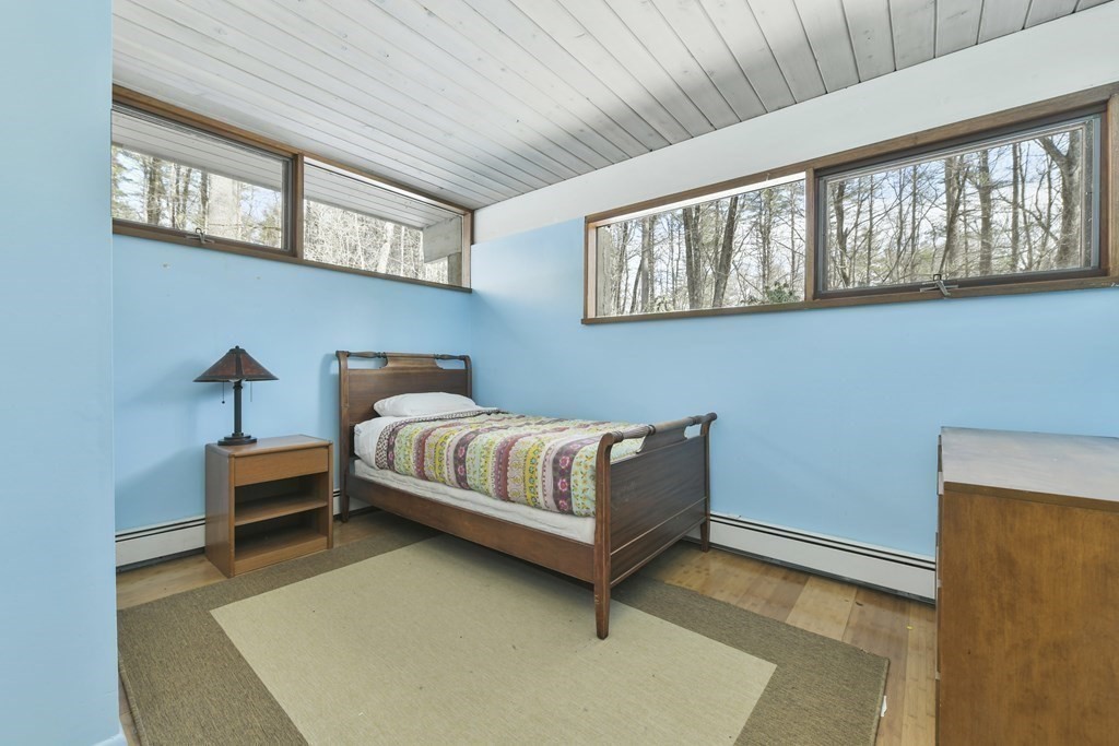 87 Wolf Rock Road Carlisle, MA 01741 - Photo 20 of 28 a bedroom with a bed and window