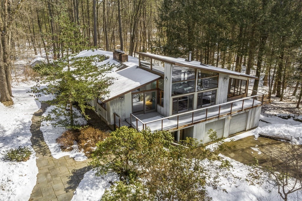 87 Wolf Rock Road Carlisle, MA 01741 - Photo 2 of 28 a view of a house with a large window and wooden fence
