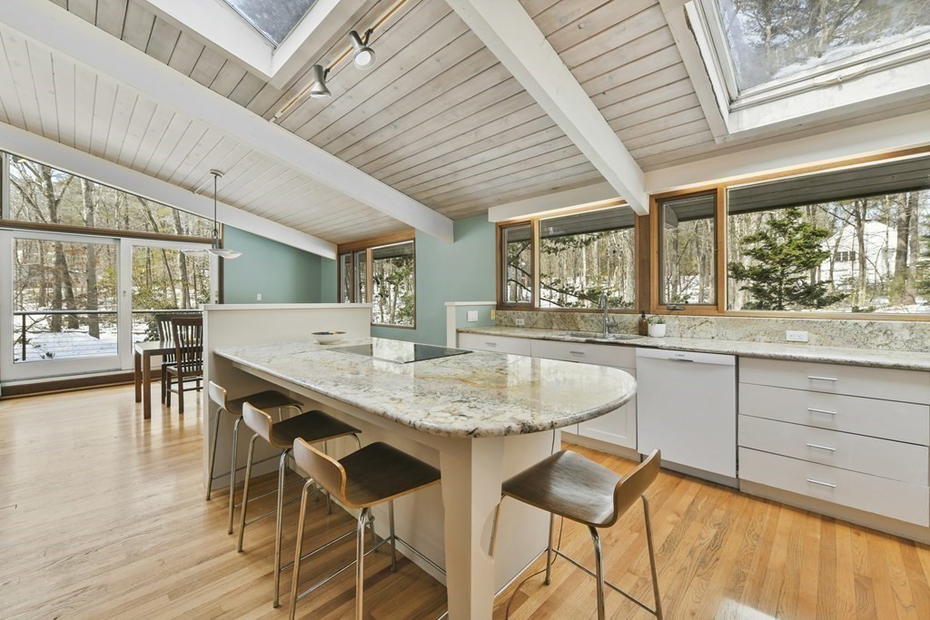 87 Wolf Rock Road Carlisle, MA 01741 - Photo 4 of 28 a kitchen with a table chairs and wooden floor