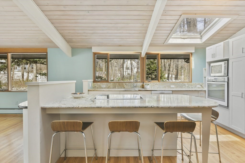 87 Wolf Rock Road Carlisle, MA 01741 - Photo 5 of 28 a kitchen with a table and chairs