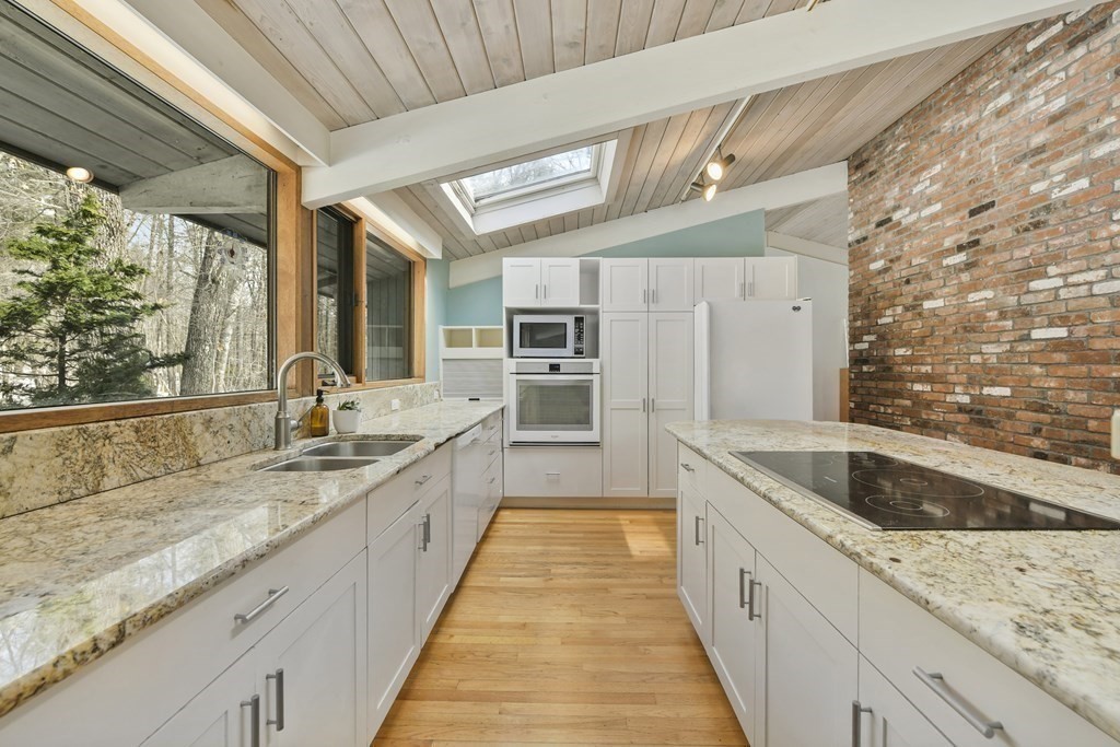87 Wolf Rock Road Carlisle, MA 01741 - Photo 6 of 28 a large white kitchen with a large window
