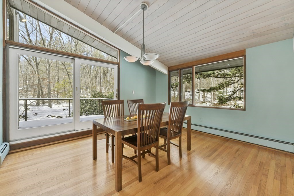 87 Wolf Rock Road Carlisle, MA 01741 - Photo 8 of 28 a dining room with furniture a chandelier and wooden floor