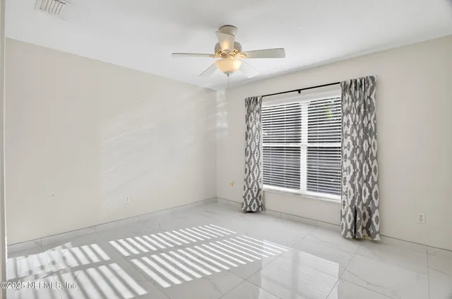 a view of a table and chairs in backyard under a umbrella