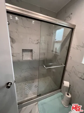 a bedroom with a bed and a chair