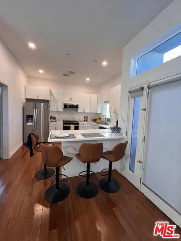 a kitchen with a sink stove top oven and cabinets