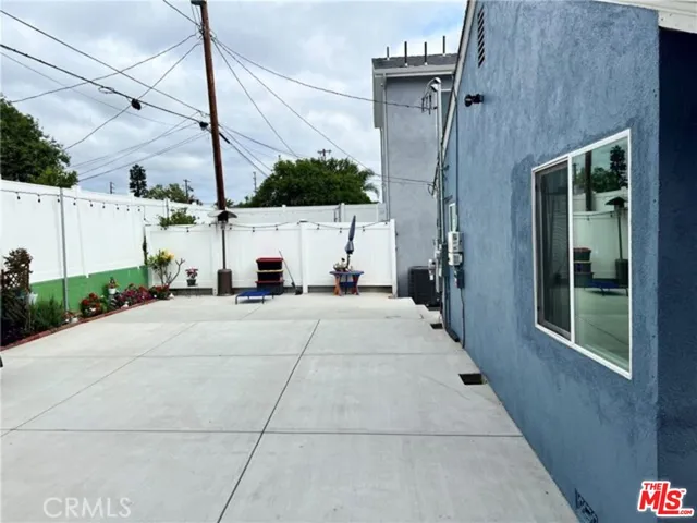 a view of a building with a cars park side of a road
