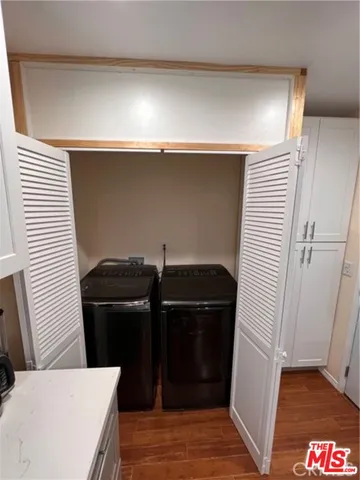 a view of a kitchen with refrigerator and windows