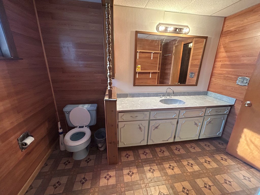 939 Watson Road Titusville, PA 16354 - Photo 14 of 39 a bathroom with a granite countertop toilet and sink