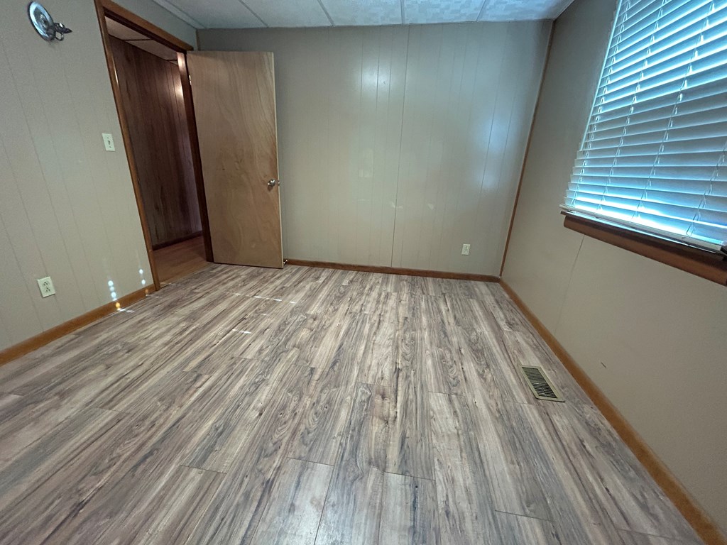 939 Watson Road Titusville, PA 16354 - Photo 21 of 39 a view of empty room with wooden floor and fan
