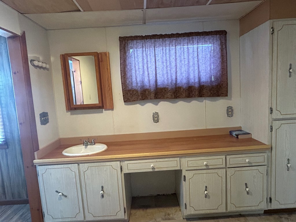 939 Watson Road Titusville, PA 16354 - Photo 22 of 39 a bathroom with a sink and a mirror