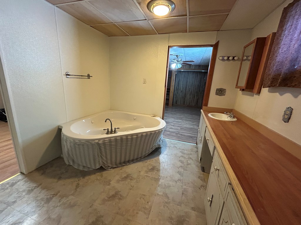 939 Watson Road Titusville, PA 16354 - Photo 23 of 39 a bathroom with a tub a sink and glass door