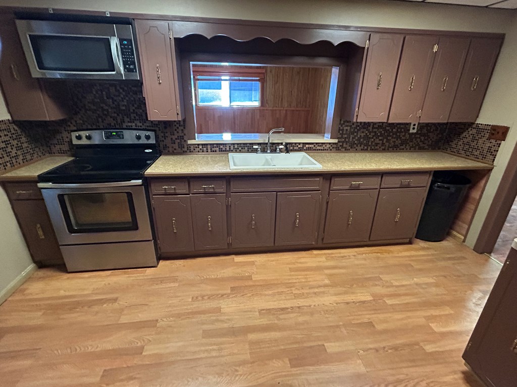 939 Watson Road Titusville, PA 16354 - Photo 3 of 39 a kitchen with stainless steel appliances granite countertop a stove a sink and a microwave