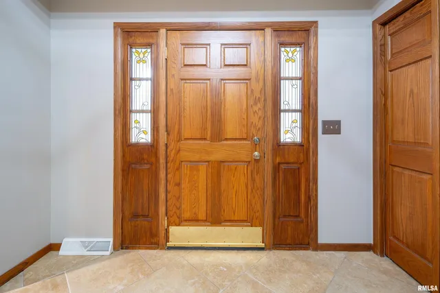 a view of an empty room with a fireplace and a window