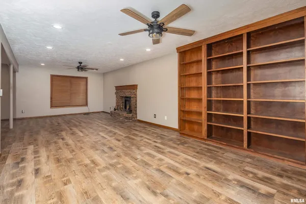 a view of an empty room with a empty shelves and a window