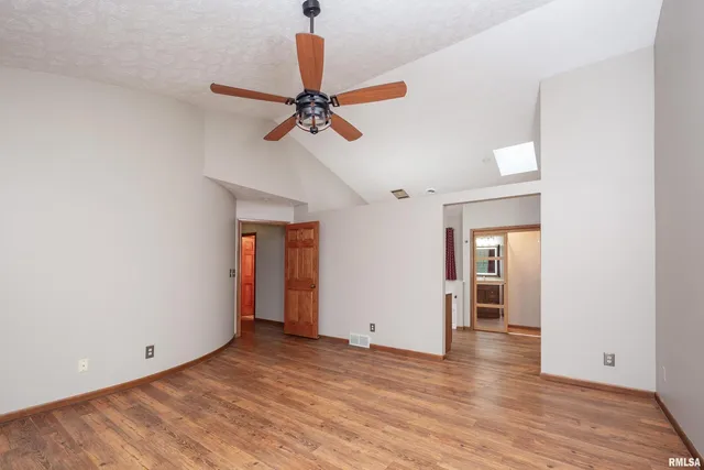 a view of a livingroom with a hardwood floor and a ceiling fan
