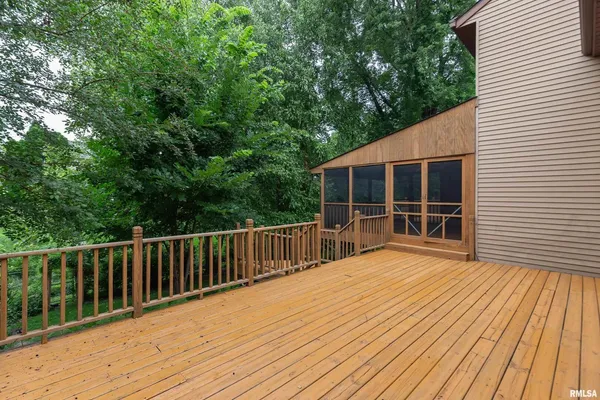 a view of backyard with deck and wooden floor