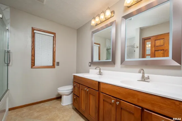 a bathroom with a sink double vanity and a mirror