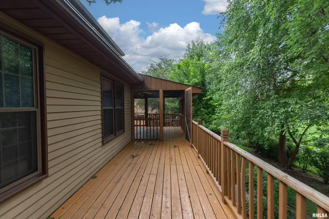 a view of balcony with wooden floor and fence