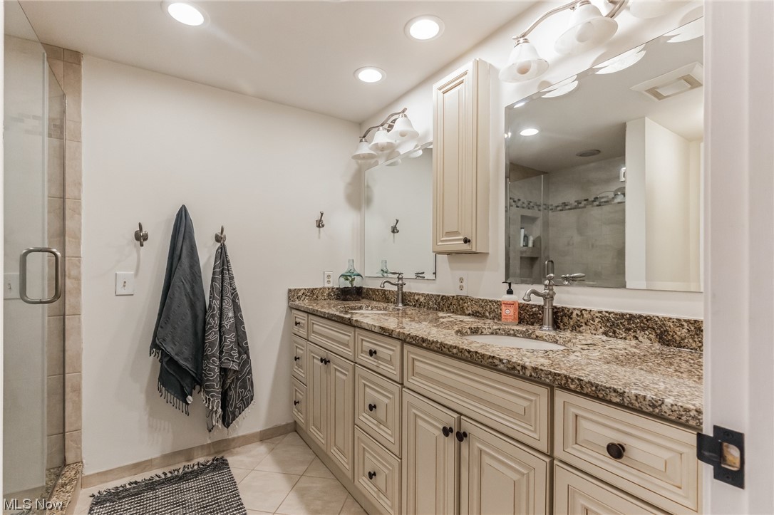 1429 Bell Road Chagrin Falls, OH 44022 - Photo 20 of 42 Owner Suite Bathroom featuring a walk-in shower with glass door, tile floors, and double sink vanity