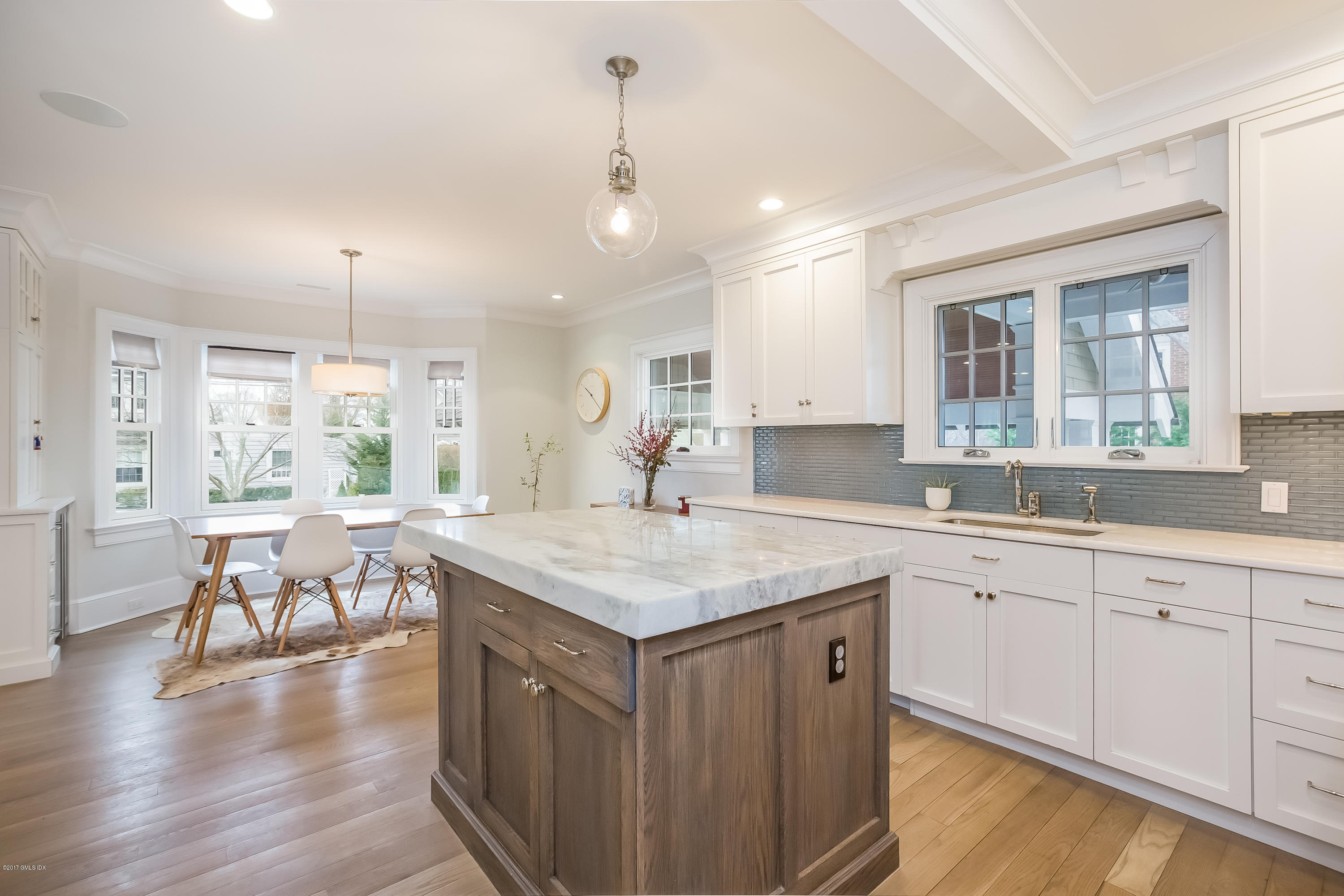 39 Edgewater Drive Old Greenwich, CT 06870 - Photo 4 of 19 a kitchen with a table chairs sink and cabinets