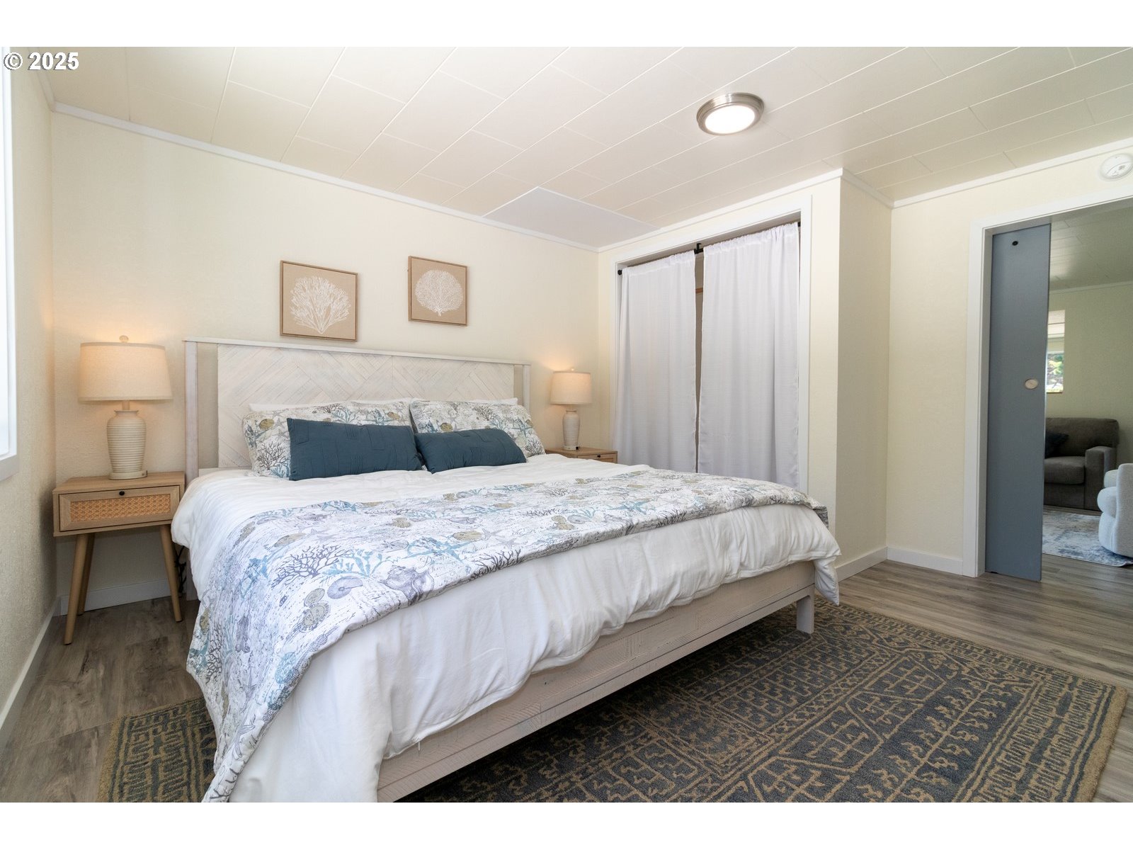 4589 Meares Street Florence, OR 97439 - Photo 13 of 35 a bedroom with a bed and wooden floor