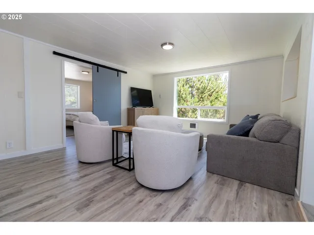 a dining room with furniture and wooden floor
