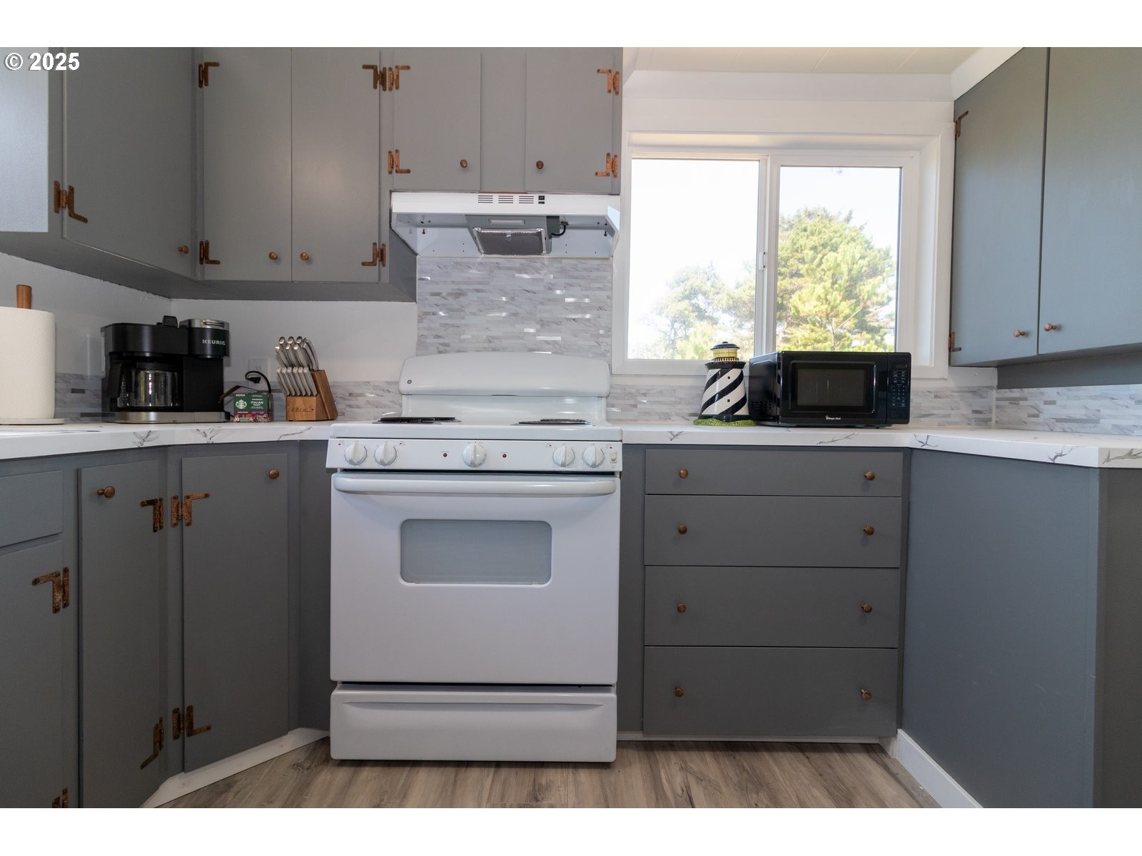 4589 Meares Street Florence, OR 97439 - Photo 20 of 35 a kitchen with cabinets appliances and a window