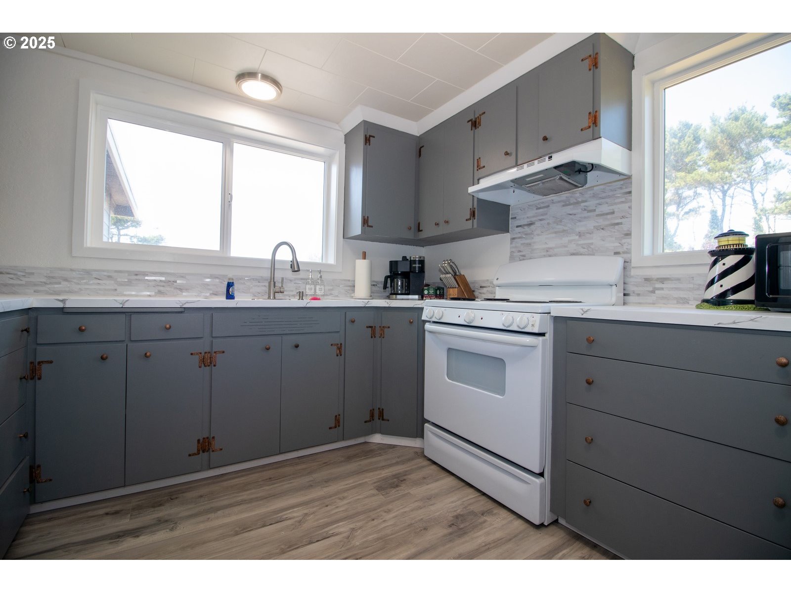 4589 Meares Street Florence, OR 97439 - Photo 21 of 35 a kitchen with a sink stove and cabinets