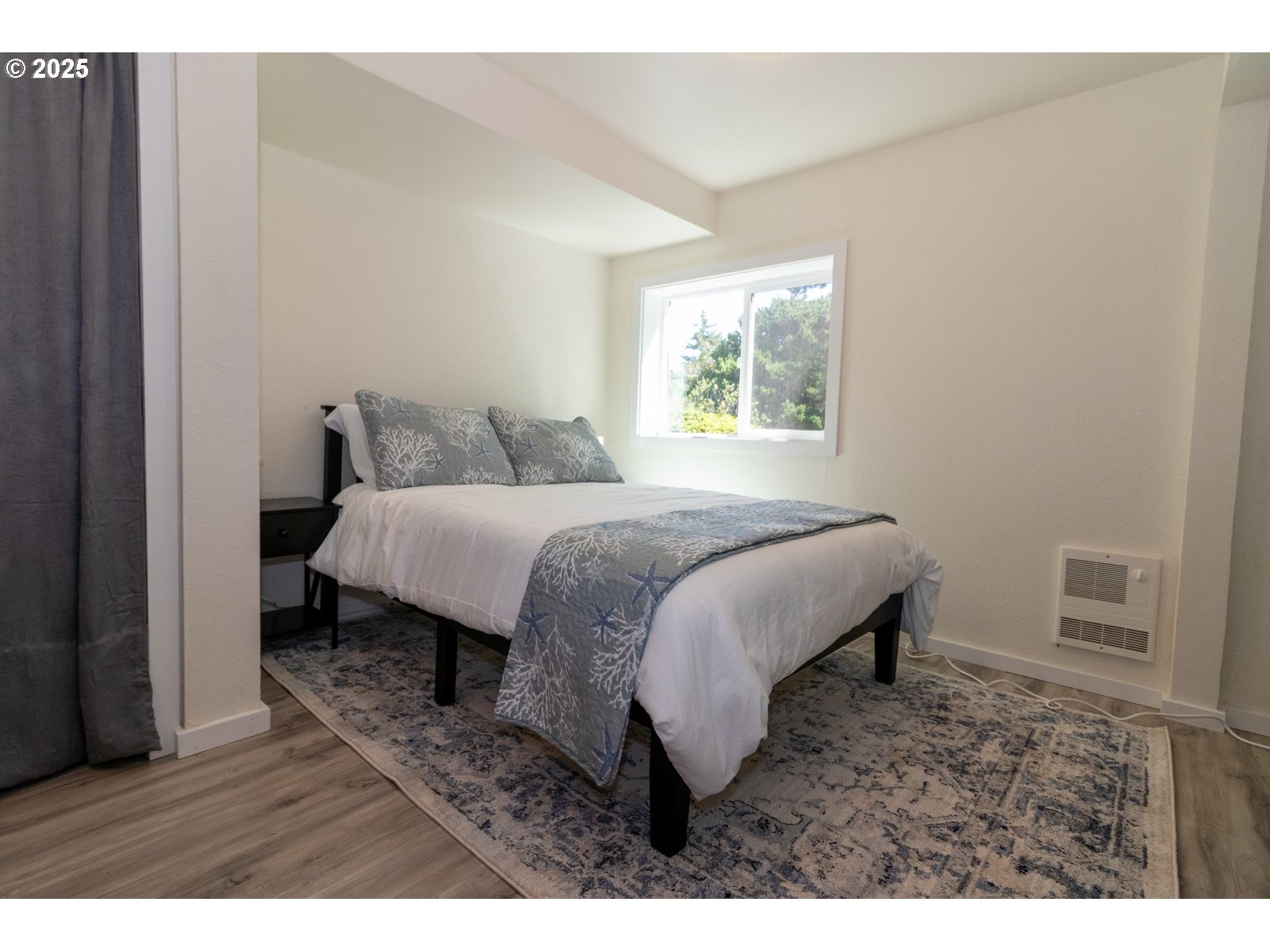 4589 Meares Street Florence, OR 97439 - Photo 27 of 35 a bedroom with a bed and a window